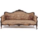 A late 19th century rosewood settee, carved flowers and foliage, on cabriole legs with knurl feet