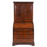 An 18th century inlaid walnut bureau bookcase, the moulded cornice above a pair of panel doors