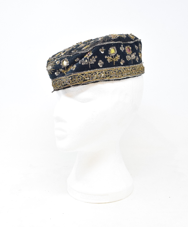 A velvet cap, embroidered with sequins, 26 cm wide, and other textiles (box)