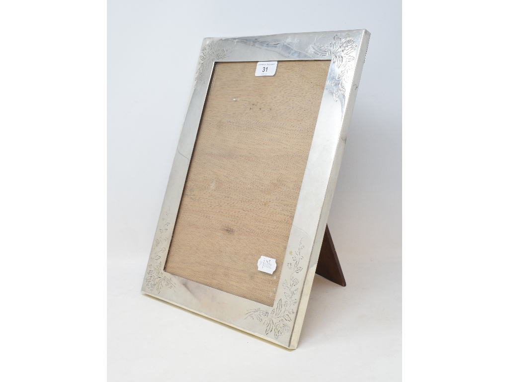 A Japanese silver coloured metal strut photograph frame, with floral decoration, 40.5 cm high