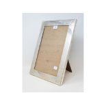 A Japanese silver coloured metal strut photograph frame, with floral decoration, 40.5 cm high