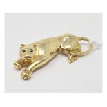 A Cartier style 14ct gold brooch/pendant in the form of a panther, with gem set eyes, approx. 11.1 g