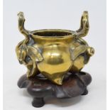 A Chinese polished bronze censer, in the form of four peaches, with two twig handles, and applied