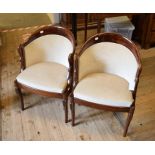 A pair of Continental armchairs, with carved swan head arms and beige upholstery