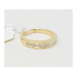 An 18ct gold and diamond half eternity ring, set princess cut stones, approx. ring size N Report