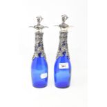 A pair of blue glass bottles, with vine plated mounts and stoppers, 28 cm high (2) Modern