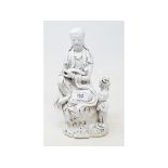 A Chinese Blanc de Chine figure, of Guanyin seated, wearing robes, the left arm cradling a ruyi