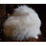 A Fortnum & Mason white fur hat, designed by Otto Lucas, boxed, a fur stole, bears a Brahams