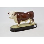 A Beswick Polled Hereford Bull, 2549A, on a ceramic base, gloss