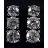 A pair of 18ct white gold and three stone diamond drop earrings See inside back cover colour