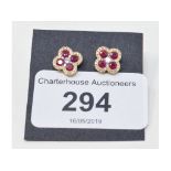 A pair of 18ct gold, ruby and diamond stud earrings, in the form of four leaf clovers Report by NG