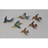 A set of three graduated Beswick Humming Bird wall plaques, 1023/3, beak restored, 2 & 1, a Swallow,