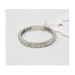 A white coloured metal and diamond eternity ring, approx. ring size U (enlarged) Report by NG