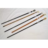 A walking stick, with a carved bone dog head handle, and four other walking sticks (5)