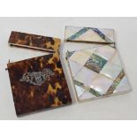 A mother of pearl card case, 8 cm wide and a tortoiseshell card case (2)