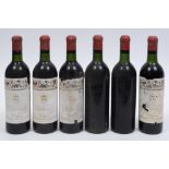 Six bottles of Chateau Mouton Rothschild, 1957, one label loose, one label missing, other labels