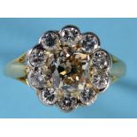 An 18ct gold and diamond flowerhead ring, the central yellow diamond within a white brilliant cut