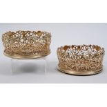 A pair of early Victorian silver gilt wine coasters, pierced flowers and foliage, crested to the