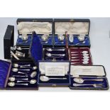 A silver three piece condiment set, one spoon replaced, Birmingham 1936, and other assorted sets,