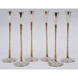 A set of six modernist silver and silver gilt candlesticks, of tapering form, on spreading