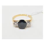An 18ct gold, sapphire and diamond three stone ring, approx. ring size R