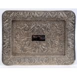 An Indian silver coloured metal rectangular tray, decorated in relief birds and trees, 41 cm wide