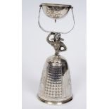 A Continental silver coloured metal wager cup, in the form of a lady wearing a crinoline dress,