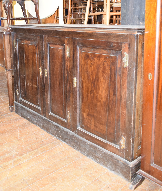 An oak side cupboard, with three panel doors, 156 cm wide