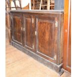 An oak side cupboard, with three panel doors, 156 cm wide