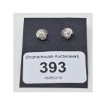 A pair of 14ct white gold and diamond stud earrings, the modern brilliant cut centre stone, set in