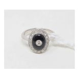 An Art Deco style 18ct white gold, onyx and diamond cluster ring, approx. ring size M