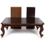 A Victorian mahogany extending dining table, inset three extra leaves (one modern), on stout leaf