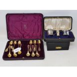 A set of twelve Continental silver gilt coloured metal spoons, initialled, lacks tongs, cased, a