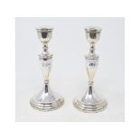 A pair of silver candlesticks, with vase shaped columns, Birmingham 1960, loaded, 20.5 cm high (2)