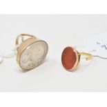 A 19th century yellow coloured metal seal ring, the mount inscribed to the reverse of the carnelian,