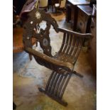 A Damascus carved, pierced and inlaid X frame folding chair