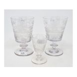 A pair of etched drinking glasses, each decorated a scene with a farmhouse, animals, a windmill