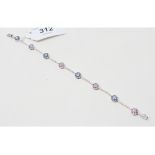 A white coloured metal, diamond, blue and pink sapphire bracelet, each diamond line interspersed