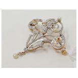 A diamond set floral spray brooch, with rubies and seed pearls, in a white and yellow coloured metal