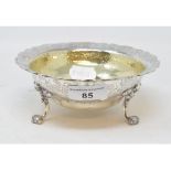 A Victorian silver and silver gilt bowl, with Rococo style decoration, on three scroll feet,