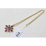 A Victorian yellow coloured metal and garnet star brooch/pendant, on a chain with later extension