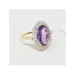 A 9ct gold, oval amethyst and diamond cluster ring, approx. ring size PÂ½ Report by NG Modern