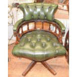 A leather upholstered swivel armchair