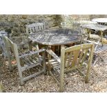 A teak garden table, 122 cm diameter, and four matching chairs (5)
