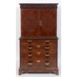 A late 17th/early 18th century cabinet on chest, veneered in walnut, and with seaweed floral