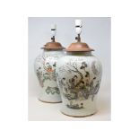 A pair of Chinese famille rose baluster vases, decorated figures, and foliage, the reverse with
