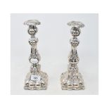 A pair of late 19th/early 20th century Continental silver coloured metal candlesticks, with