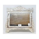 A mirror, in a silver coloured metal frame, 34 cm wide