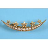 A crescent brooch, set seed pearls applied five gold stars with diamond centres, in a yellow