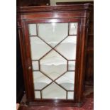 A 19th century stained pine hanging corner cupboard, with a bar glazed door, 80 cm wide